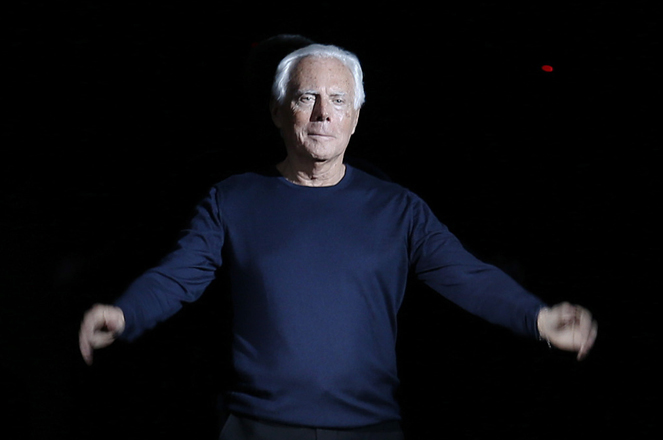 Giorgio Armani acknowledges the audience at the end of the Giorgio Armani Autumn/Winter 2014 collection during Milan Fashion Week