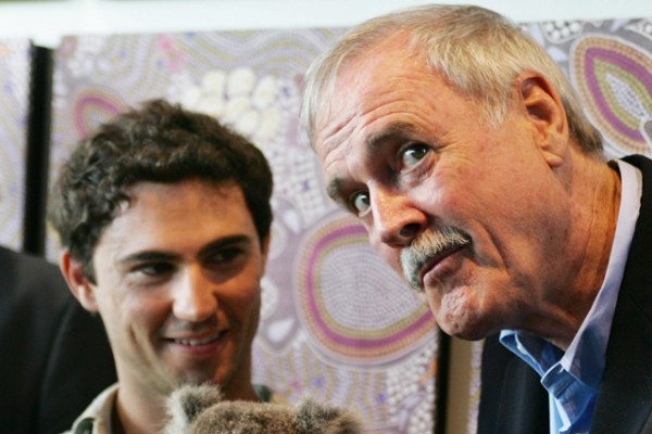 British comedian John Cleese reacts as he poses with 'McAuley' the Koala at Taronga Zoo in Sydney