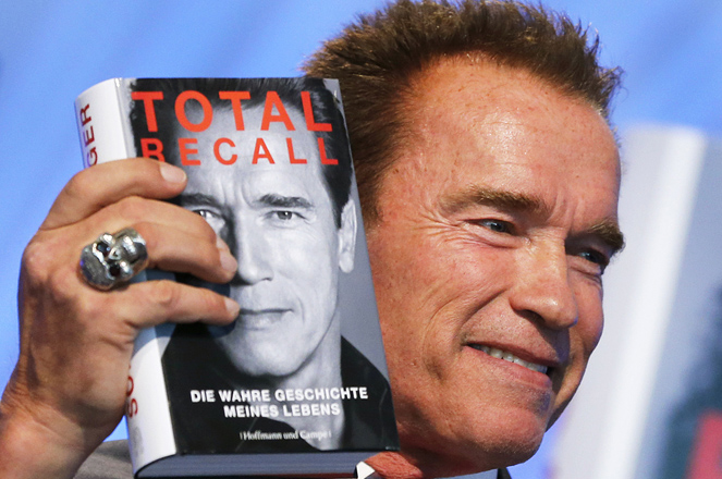 Former state governor of California, Arnold Schwarzenegger displays his book 