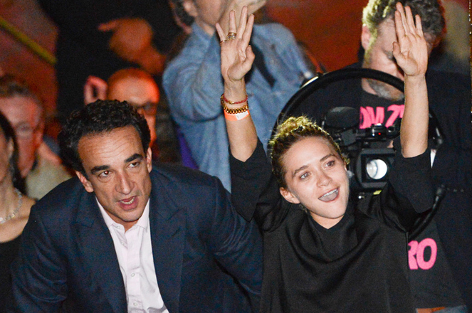 Mary-Kate Olsen and boyfriend Olivier Sarkozy in the audience at The Cutting Room to see Ronnie Wood of the Rolling Stones perform with guitarist Mick Taylor, drummer Simon Kirke and keyboardist Al Cooper on Thursday, Nov. 7, 2013 in New York. (Photo by Evan Agostini/Invision/AP)