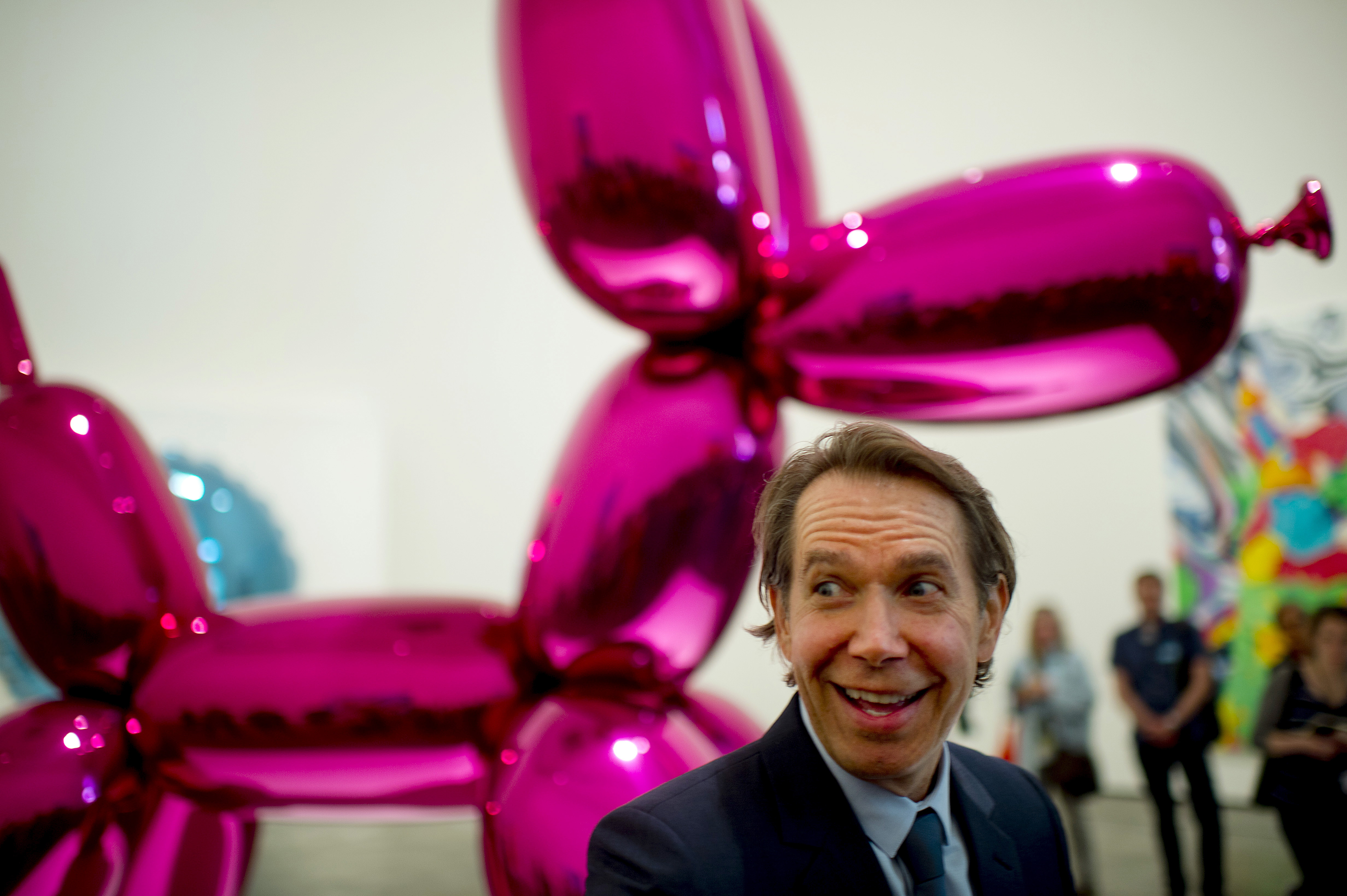 U.S. artist Jeff Koons stands in front of the stainless steel sculpture Balloon Dog during the presentation of 