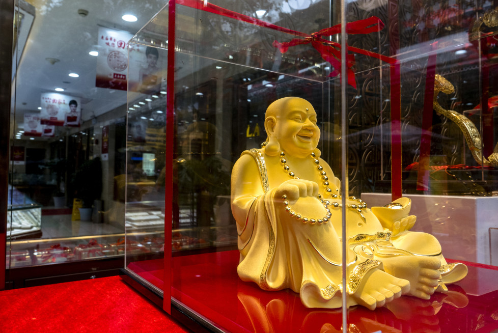 SHANGHAI, CHINA - 2015/11/20: A gold Maitreya Buddha showed in a gold shop's window. An overbuilt property market and a devaluation of the yuan have already made Chinese investors the worlds largest consumers of gold. (Photo by Zhang Peng/LightRocket via Getty Images)