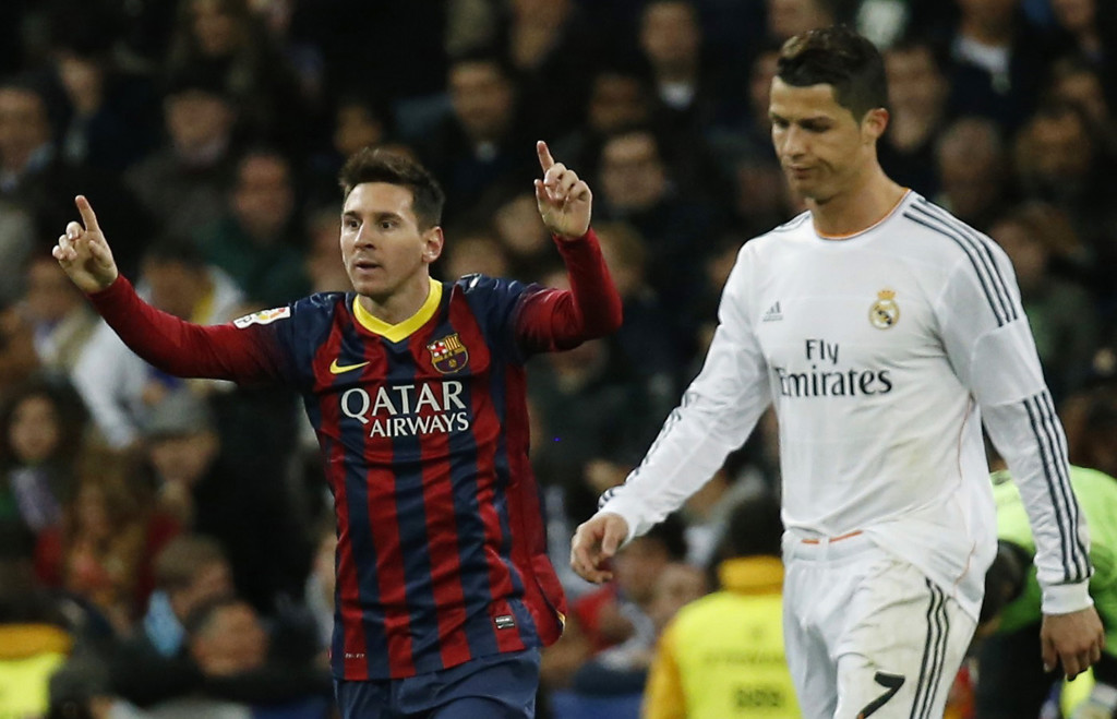 Barcelona's Lionel Messi (L) celebrates a goal next to Real Madrid's Cristiano Ronaldo during La Liga's second 'Clasico' soccer match of the season at Santiago Bernabeu stadium in Madrid March 23, 2014. REUTERS/Paul Hanna (SPAIN - Tags: SPORT SOCCER TPX IMAGES OF THE DAY) - RTR3IAYQ
