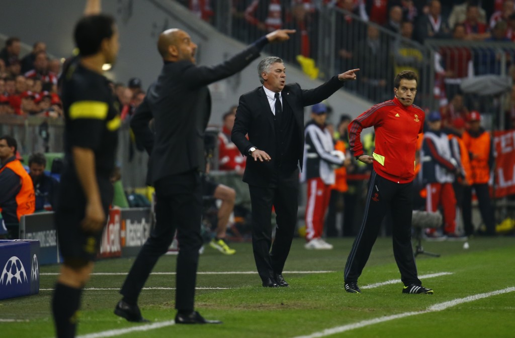 Bayern Munich's coach Josep Guardiola and Real Madrid's coach Carlo Ancelotti (2nd R) gesture to their players during their Champion's League semi-final second leg soccer match in Munich April 29, 2014. REUTERS/Kai Pfaffenbach (GERMANY - Tags: SPORT SOCCER) - RTR3N4UT
