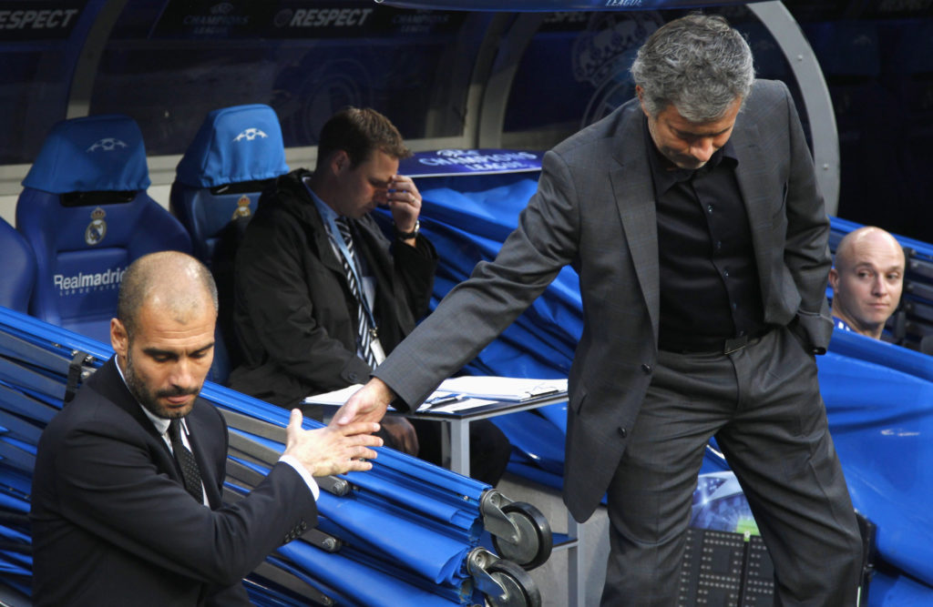 Real Madrid's coach Jose Mourinho (R) shakes hands with Barcelona's coach Pep Guardiola before their Champions League semi-final first leg soccer match at Santiago Bernabeu stadium in Madrid April 27, 2011. REUTERS/Sergio Perez (SPAIN - Tags: SPORT SOCCER) - RTR2LOFS
