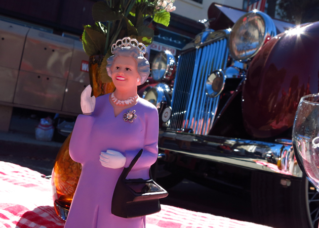 A figurine of a waving Queen Elizabeth, is displayed in front of a 1937 MG VA Tourer during the Little Car Show in Pacific Grove, California, August 13, 2014. The event, which showcases small cars with up to 1,601cc engines as well as electric cars, is held during the Pebble Beach Automotive Week which culminates with the Concours d'Elegance. REUTERS/Michael Fiala (UNITED STATES - Tags: SOCIETY TRANSPORT) - RTR42CGJ