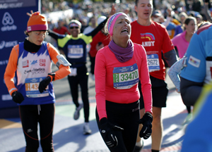 Runner reacts after crossing the finish line of the 2014 New York City Marathon in Central Park in Manhattan
