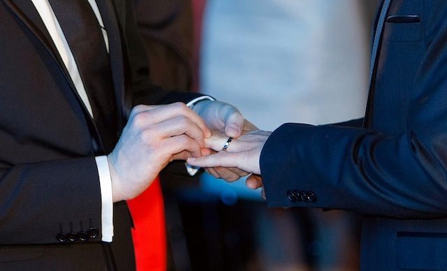 Vincent Autin, left, puts the ring on the finger at Bruno Boileau, during their civil wedding at Montpelier City Hall, Wednesday May 29, 2013. Bruno Boileau, 30, from Paris and Vincent Autin, 40, are the first same-sex couple to marry in France, since French government voted a new law legalizing same-sex marriage.(AP Photo/Claude Paris)