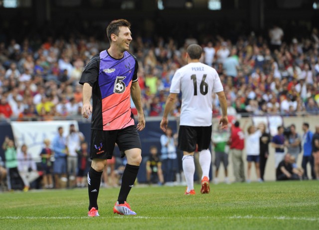 Messi's Friends' Lionel Messi smiles as he stands on the field against the Rest of the World during the first half of the Messi and Friends charity soccer exhibition, Saturday, July 6, 2013 in Chicago. Messi's Friends won 9-6.  (AP Photo/Brian Kersey)