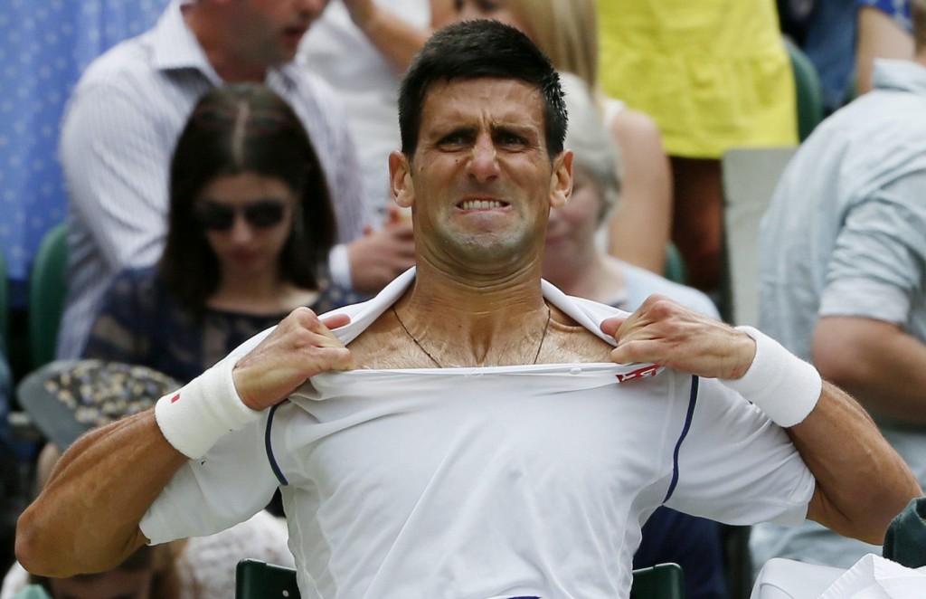 Novak Djokovic of Serbia changes his shirt during his Men's Singles Final match against Roger Federer of Switzerland at the Wimbledon Tennis Championships in London, July 12, 2015.                                                       REUTERS/Stefan Wermuth TPX IMAGES OF THE DAY