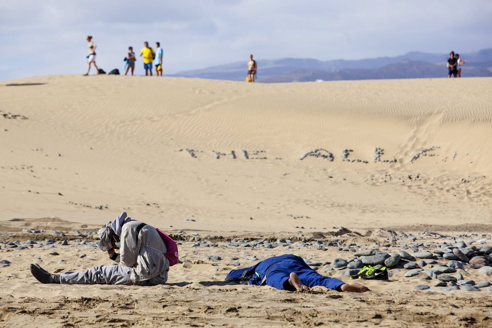 Two would-be immigrants rest at Maspalomas beach on Gran Canaria in Spain's Canary Islands in this November 5, 2014 file photo. Italy stepped up calls for a change to European asylum rules on Sunday as neighbouring states tightened border controls, turning back African migrants and leaving hundreds stranded at the frontier in northern Italy.  REUTERS/Borja Suarez/Files ATTENTION EDITORS - THIS PICTURE IS PART OF THE PACKAGE "IN PLAIN SIGHT". TO FIND ALL 9 IMAGES SEARCH 'MIGRANT EUROPEAN'.