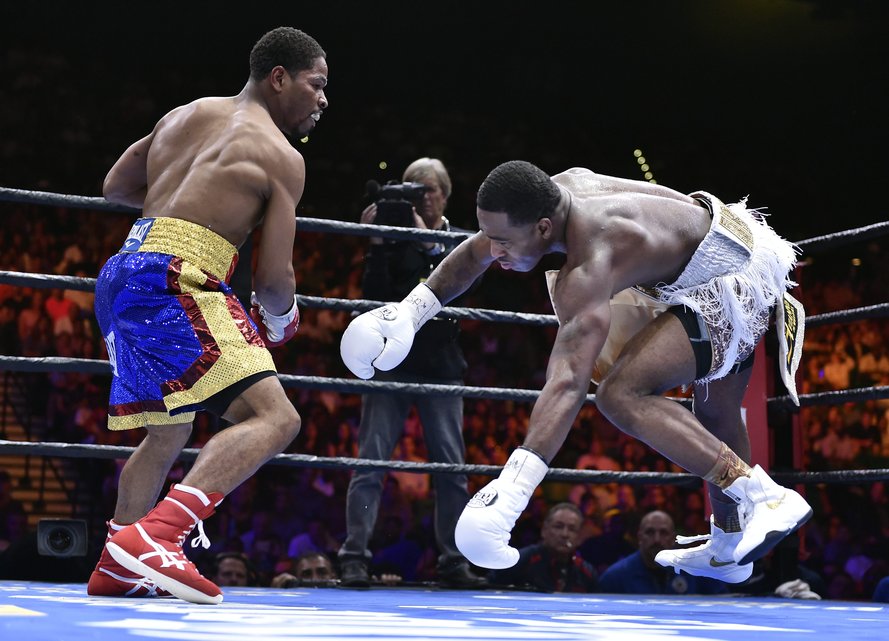Shawn Porter, left, knocks Adrien Broner off-balance during a welterweight fight on Saturday, June 20, 2015, in Las Vegas. Porter won by unanimous decision after a 12-round bout. (AP Photo/David Becker)