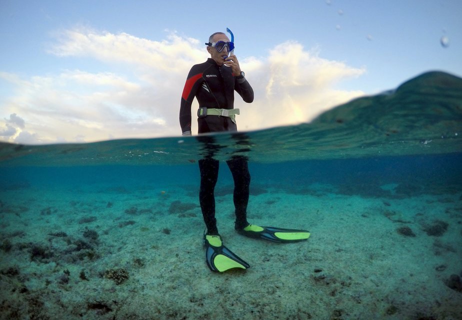 Peter Gash, owner and manager of the Lady Elliot Island Eco Resort, prepares to snorkel during an inspection of the reef's condition in an area called the 'Coral Gardens' located at Lady Elliot Island, north-east of the town of Bundaberg in Queensland, Australia, June 11, 2015. Gash snorkels every morning before he attends to managing duties on the island. UNESCO World Heritage delegates recently snorkelled on AustraliaÄôs Great Barrier Reef, thousands of coral reefs, which stretch over 2,000 km off the northeast coast. Surrounded by manta rays, dolphins and reef sharks, their mission was to check the health of the world's largest living ecosystem, which brings in billions of dollars a year in tourism. Some coral has been badly damaged and animal species, including dugong and large green turtles, are threatened. UNESCO will say on Wednesday whether it will place the reef on a list of endangered World Heritage sites, a move the Australian government wants to avoid at all costs, having lobbied hard overseas. Earlier this year, UNESCO said the reef's outlook was "poor". REUTERS/David Gray PICTURE 14 OF 23 FOR WIDER IMAGE STORY "GREAT BARRIER REEF AT RISK" SEARCH "GRAY REEF" FOR ALL PICTURES