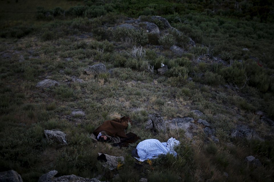 Shepherds sleep outside as they herd their flock to summer pastures in Serra da Estrela, near Seia, Portugal June 28, 2015. In late June, shepherds young and old in the Seia region of central Portugal start guiding sheep, goats and cattle to the Serra da Estrela, the countryÄôs highest mountains, in search of better pastures. There they stay until the end of September. Modern-day shepherds may have mobile phones to keep in touch with family and friends, but their lifestyle has changed little for centuries. The sound of cowbells and the bark of longhaired mastiffs starts early in the morning as the animals Äì often decorated with traditional woollen balls on their horns - are herded up steep, narrow paths. REUTERS/Rafael Marchante PICTURE 18 OF 23 FOR WIDER IMAGE STORY "OLD TRADITIONS, NEW PASTURES" SEARCH "SERRA DA ESTRELA" FOR ALL PICTURES