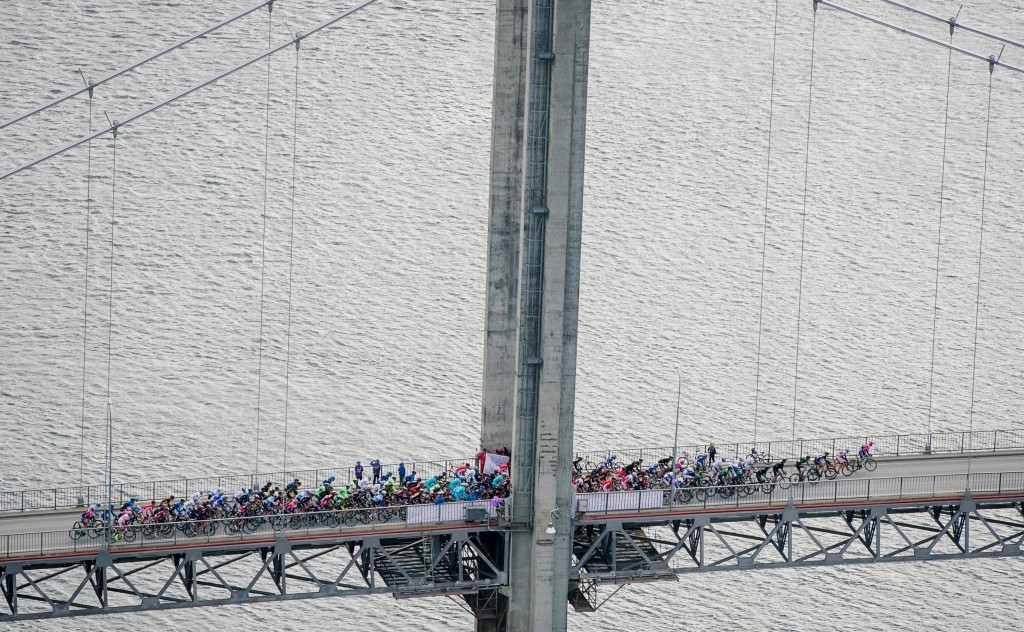 Cyclists pass a bridge during the 213,5 km first stage of the Arctic Race of Norway with start and end point in Harstad, northern Norway, on August 13, 2015. The Arctic Race of Norway takes place in northern Norway until August 16.  AFP PHOTO / JONATHAN NACKSTRAND