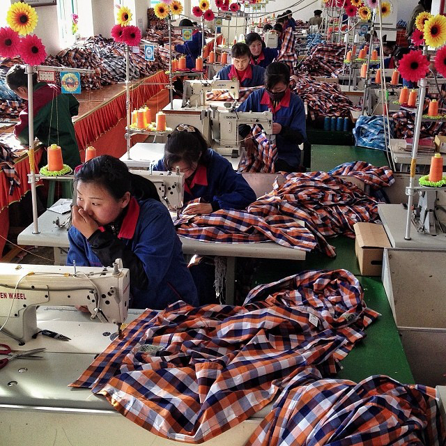 North Korean seamstresses work at rows of sewing machines at the Sonbong Textile Factory inside the Rason Special Economic Zone. (AP Photo/David Guttenfelder)