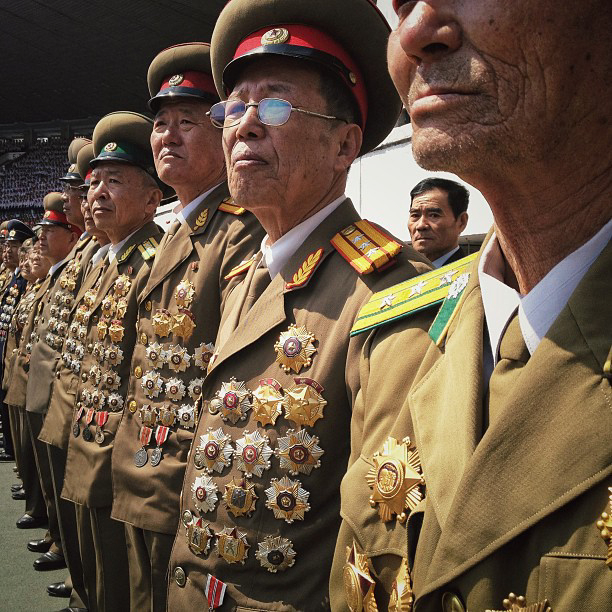 Chests festooned with medals, North Korean retired military members stand at attention in Pyongyang. (AP Photo/David Guttenfelder)