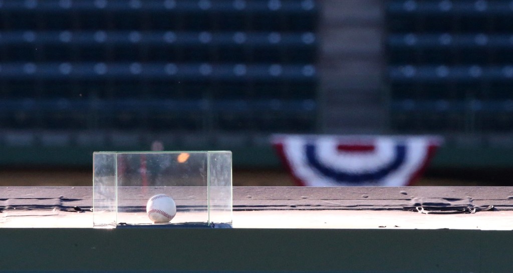 A baseball that was hit for a home run by Chicago Cubs' Kyle Schwarber in the seventh inning in Tuesday's Game 4 of the NLDS sits atop the right field video board at Wrigley Field in Chicago, Wednesday, Oct. 14, 2015. A protective plastic box was placed around the ball by the Cubs organization earlier in the day. (Chris Sweda/Chicago Tribune via AP)