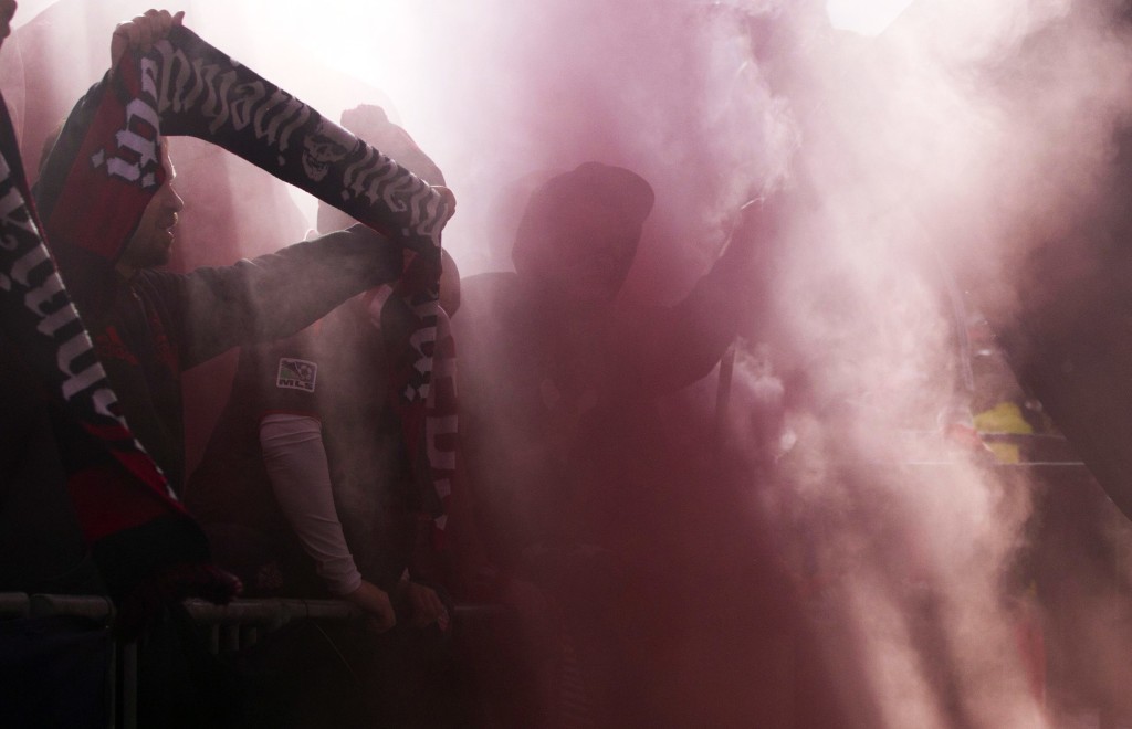 Toronto FC fans cheer through the haze of smoke flares during the team's 2-0 loss to the Columbus Crew in an MLS soccer game in Toronto, Saturday, Oct. 17, 2015. (Chris Young/The Canadian Press via AP) MANDATORY CREDIT