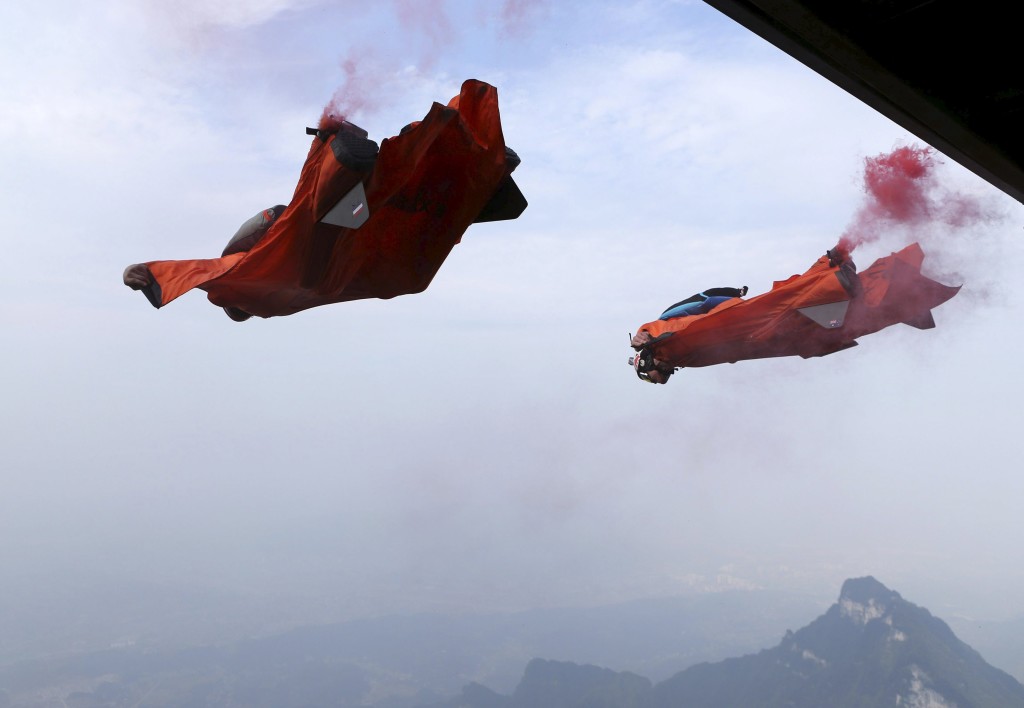 Wingsuit flyer contestants jump off a mountain during the fourth World Wingsuit Flying Tournamentat at the Tianmen Mountain National Park in Zhangjiajie, Hunan province, China, October 18, 2015. Picture taken October 18, 2015. REUTERS/China Daily CHINA OUT. NO COMMERCIAL OR EDITORIAL SALES IN CHINA