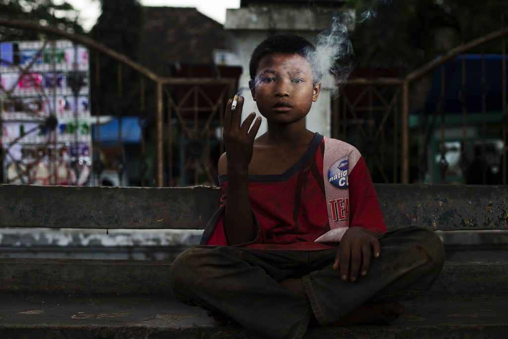 Cecep poses for a photo as he smokes on February 10, 2014. (Photo By: Michelle Siu)