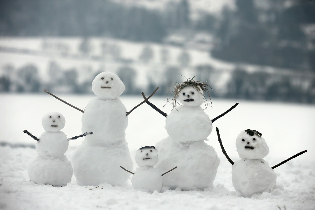 DORKING, UNITED KINGDOM - JANUARY 19: A family of snowmen sit on Box Hill on January 19, 2013 in Dorking, United Kingdom. Heavy snow around the UK caused hundreds of flight cancelations at Heathrow, with more travel disruptions expected during a snowy weekend. Approximately 3,000 schools were closed in England, Wales and Scotland. (Photo by Dan Kitwood/Getty Images)