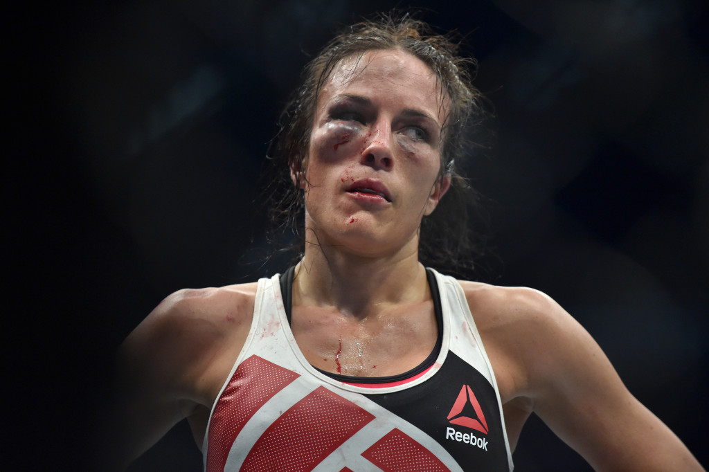 A beaten Valerie Letourneau of Canada gestures after Joanna Jedrzejczyk of Poland retained her UFC Strawweight title in Melbourne on November 15, 2015. RESTRICTED TO EDITORIAL USE NO ADVERTISING USE NO PROMOTIONAL USE NO MERCHANDISING USE. AFP PHOTO/Paul CROCK / AFP / PAUL CROCK