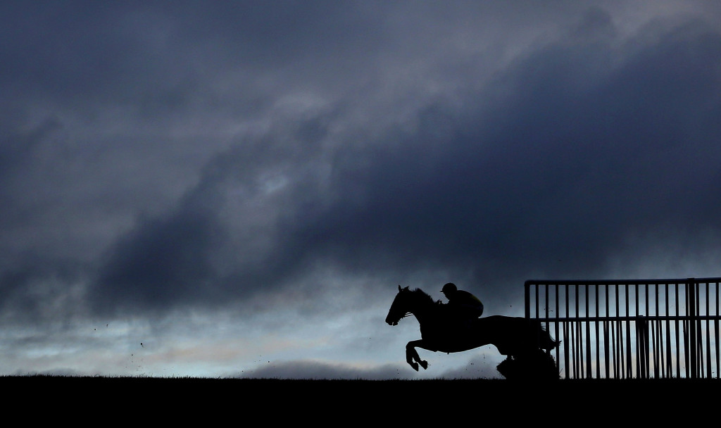 WINCANTON, ENGLAND - NOVEMBER 19: A general view as a runner clears a flight of hurdles on the back straight at Wincanton racecourse on November 19, 2015 in Wincanton, England. (Photo by Alan Crowhurst/Getty Images)