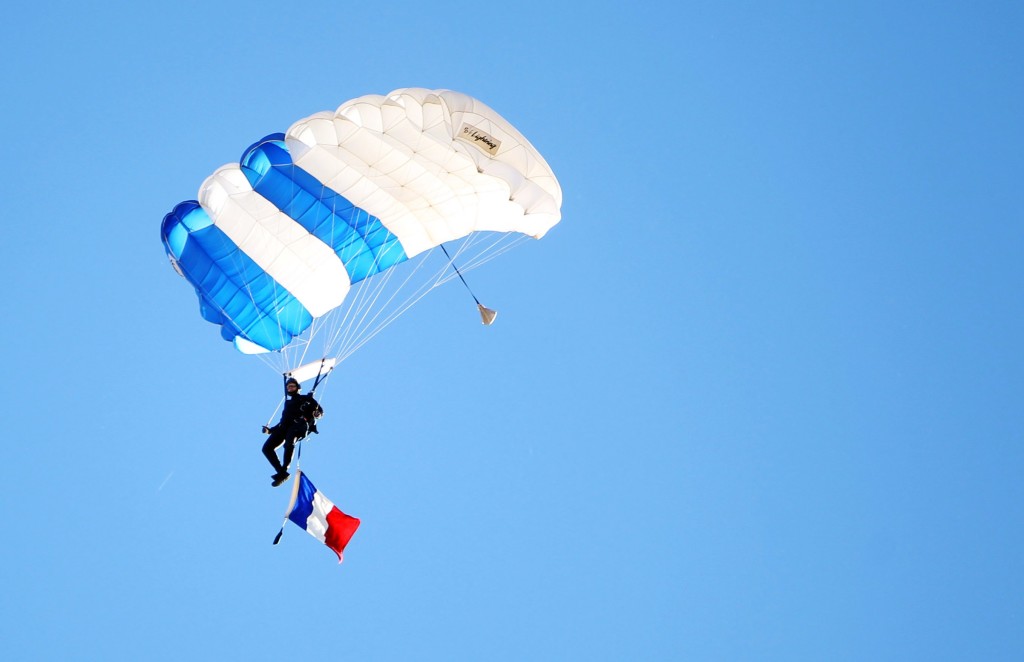 Nov 14, 2015; Colorado Springs, CO, USA; An Air Force parachuter flies onto the field before the game with a French flag in honor of the victims of the November 13th terror attacks in Paris before the game between the Air Force Falcons and the Utah State Aggies at Falcon Stadium. Mandatory Credit: Chris Humphreys-USA TODAY Sports
