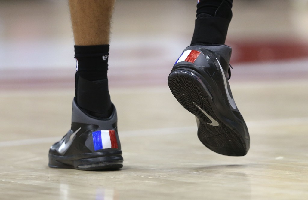 Utah Jazz center Rudy Gobert (27), of France, wears shoes decorated with French flags in the second half of an NBA basketball game against the Atlanta Hawks, Sunday, Nov. 15, 2015, in Atlanta. Utah won 97-96. (AP Photo/John Bazemore)