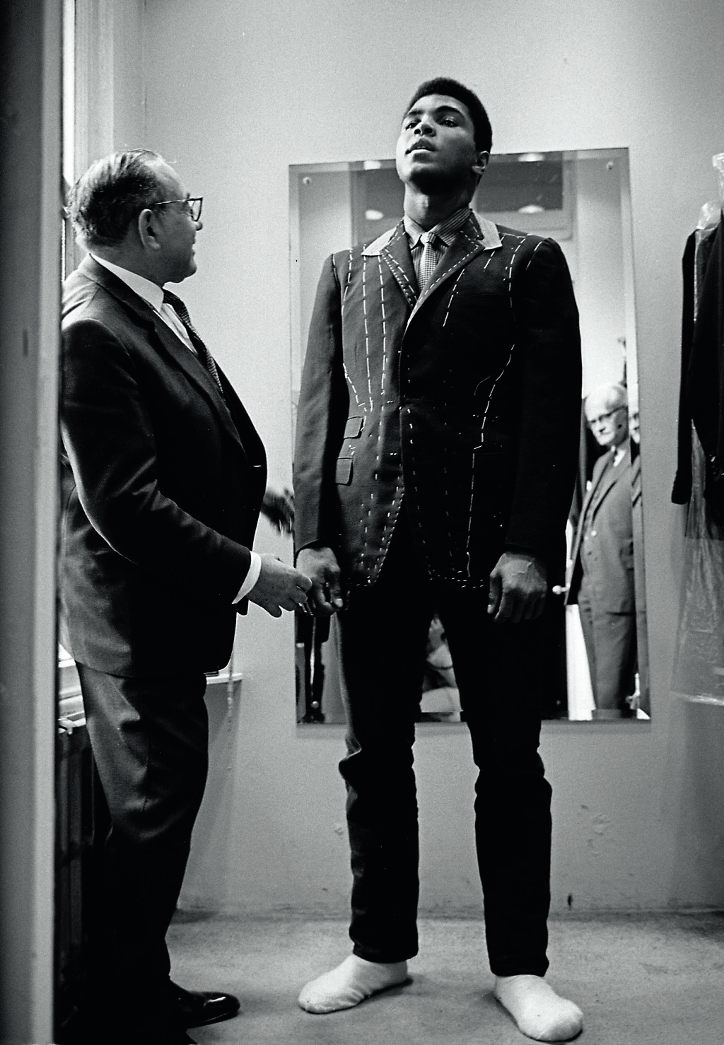 Muhammad Ali (then Cassius Clay), boxing world heavy weight champion at a taylor in London being fitted for a new suit. HOT1966015W02706-8A © Thomas Hoepker / MAGNUM