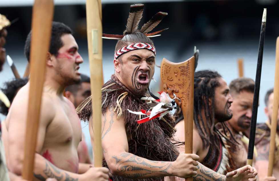 Maori men perform a haka as the casket of late New Zealand All Blacks rugby legend Jonah Lomu is carried onto Eden Park during a memorial service in Auckland on November 30, 2015. Lomu's career was cut short by a chronic kidney disease and he died unexpectedly at his Auckland home on November 18 aged just 40, leaving a wife and two young sons. / AFP / MICHAEL BRADLEY