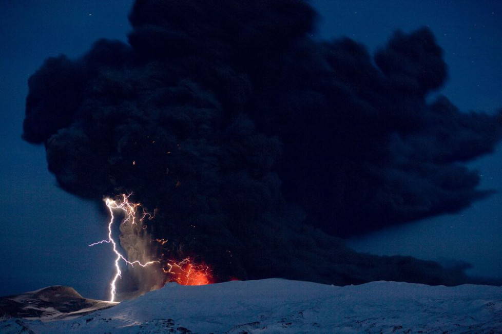 Lighting seen amid the lava and ash erupting from the vent of the Eyjafjallajokull volcano in central Iceland early morning Sunday April 18 2010 as it continues to vent into the skies over Europe. Low-energy lightning is sometimes active during eruptions, arcing between particles as they exit the volcanic vent at around 100 metres per second. The dramatic volcanic eruption which has closed Europe's airspace for days has entered a new phase - producing less smoke but bubbling with lava and throwing up chunks of molten rock. (KEYSTONE/AP Photo/ Jon Pall Vilhelmsson)