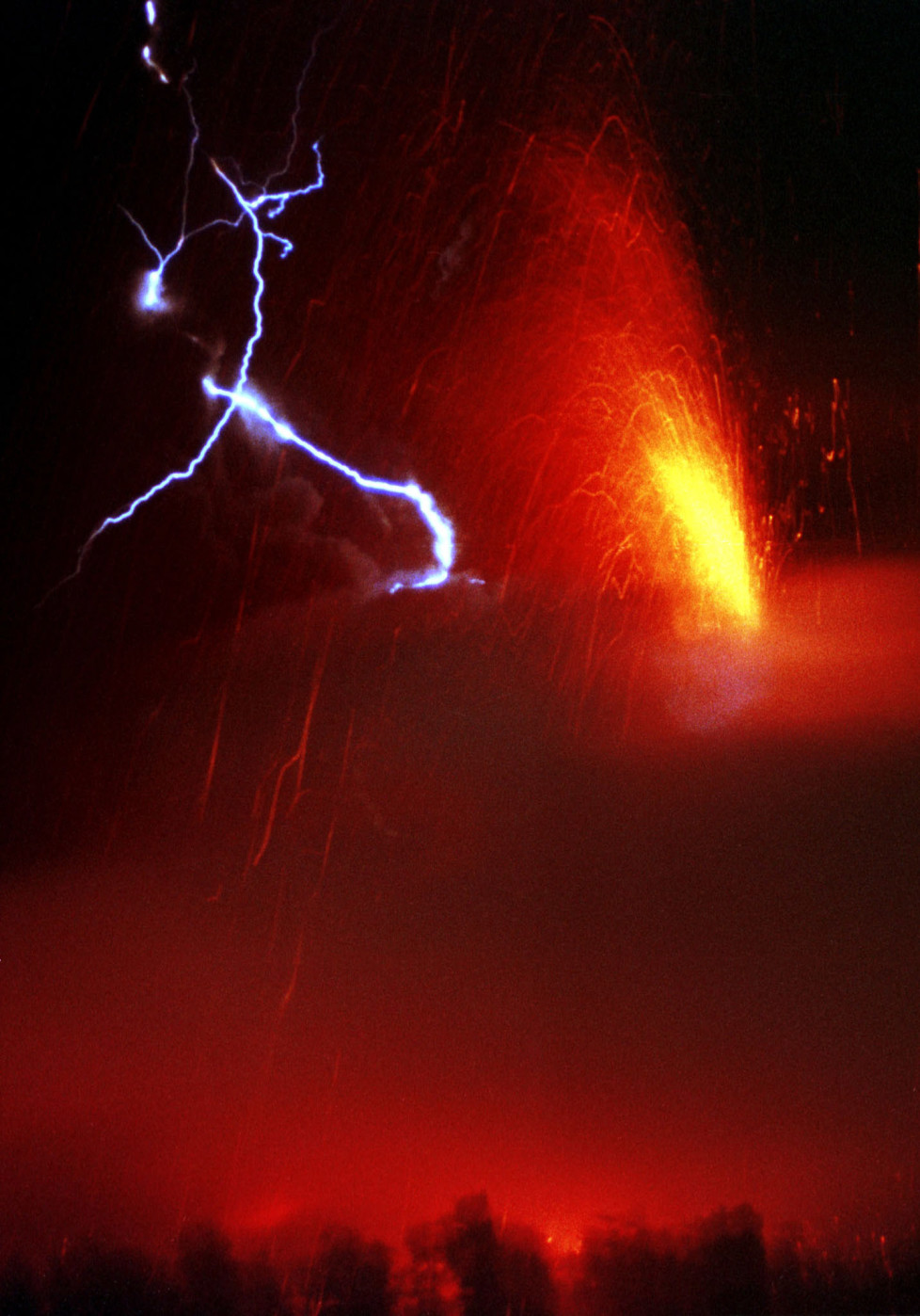 Lightning strikes over Pacaya Volcano, while it erupts lava and ash in Amatitlan, Guatemala, January 17, 2000. The Pacaya volcano, some 30 miles (48 km) south of the capital, spewed lava 3,000 feet (914 meters) into the air. RM/ME - RTRBTWU