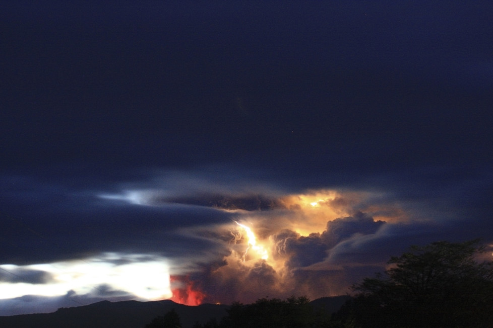 Lightning bolts strike around the Puyehue-Cordon Caulle volcanic chain in the Patagonia region at sunrise June 5, 2011. The volcano dormant for decades erupted in south-central Chile on Saturday, belching ash over 6 miles (10 km) into the sky, as winds fanned it toward neighboring Argentina, and prompting the government to evacuate several thousand residents, Chilean authorities said. REUTERS/Carlos Gutierrez (CHILE - Tags: DISASTER ENVIRONMENT IMAGES OF THE DAY) - RTR2NBMM