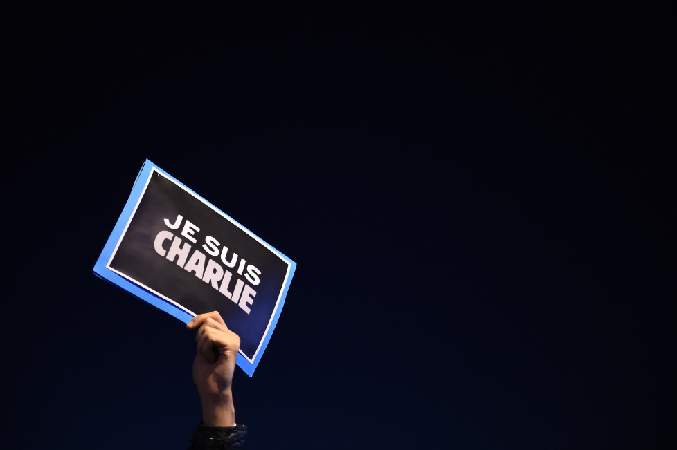 A man holds a placard reading "I am Charlie" on the Old Harbor in Marseille, southern France, on January 7, 2015, following an attack by unknown gunmen on the offices of the satirical weekly, Charlie Hebdo. France's Muslim leadership sharply condemned the shooting at the Paris satirical weekly that left at least 12 people dead as a "barbaric" attack and an assault on press freedom and democracy. AFP PHOTO / ANNE-CHRISTINE POUJOULAT / AFP / ANNE-CHRISTINE POUJOULAT