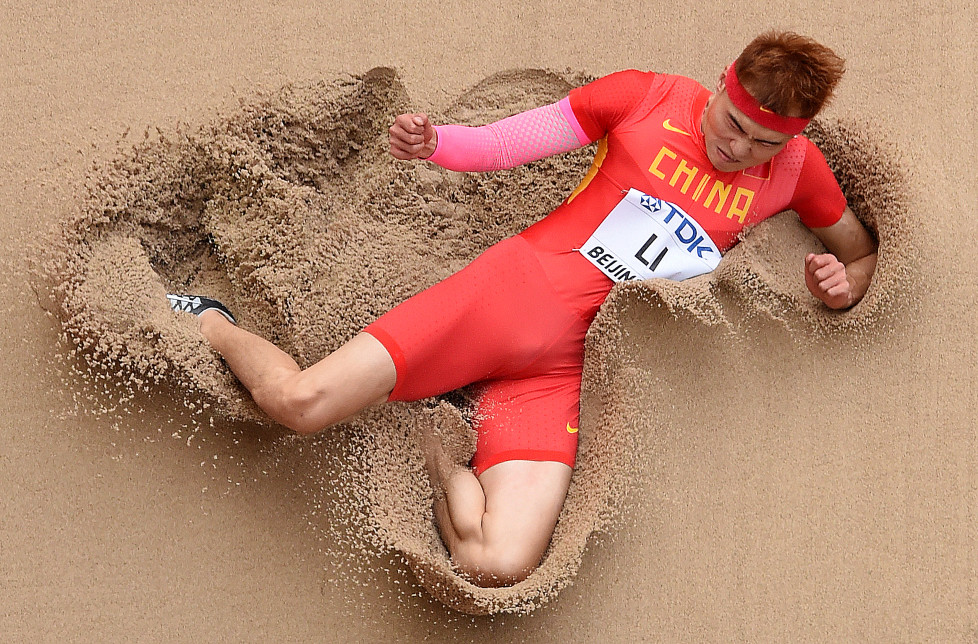 China's Li Jinzhe competes in the qualifying round of the men's long jump athletics event at the 2015 IAAF World Championships at the "Bird's Nest" National Stadium in Beijing on August 24, 2015. AFP PHOTO / ANTONIN THUILLIER / AFP / ANTONIN THUILLIER
