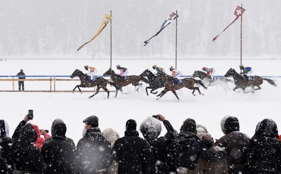 FILE - In this Feb. 15, 2015 file photo eventual winner Fox Kieren rides Berrahri, far left, as he competes during the GP Christoffel Bau Trophy on the frozen Lake St. Moritz on the second weekend of the White Turf races in St. Moritz, Switzerland. (Gian Ehrenzeller/Keystone via AP, file)