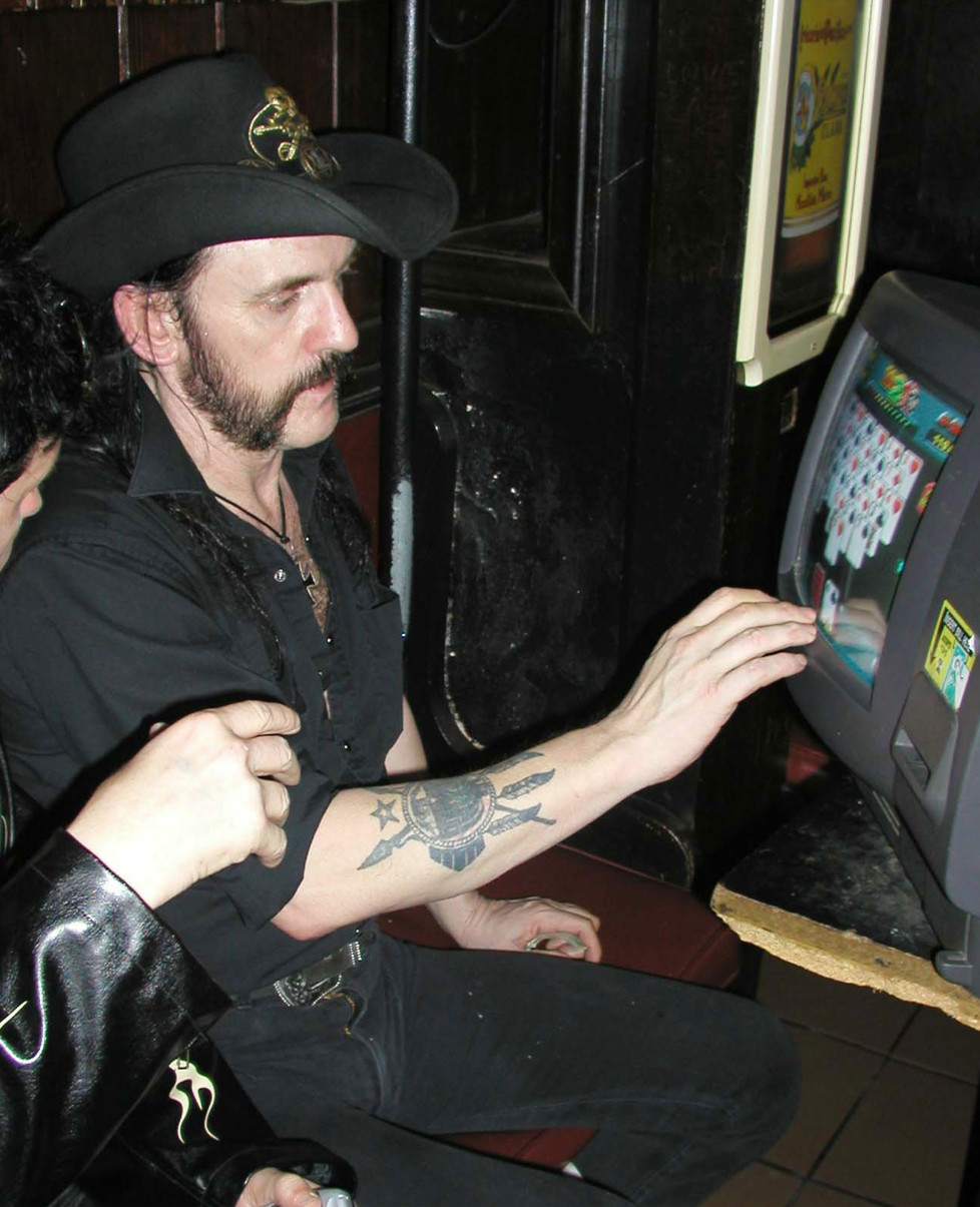 WEST HOLLYWOOD - CA: Motorhead singer Lemmy Kilmister plays video poker at the Rainbow Bar & Grill, September 2, 2003 in West Hollywood California. (Photo by Alexander Sibaja/Getty Images)