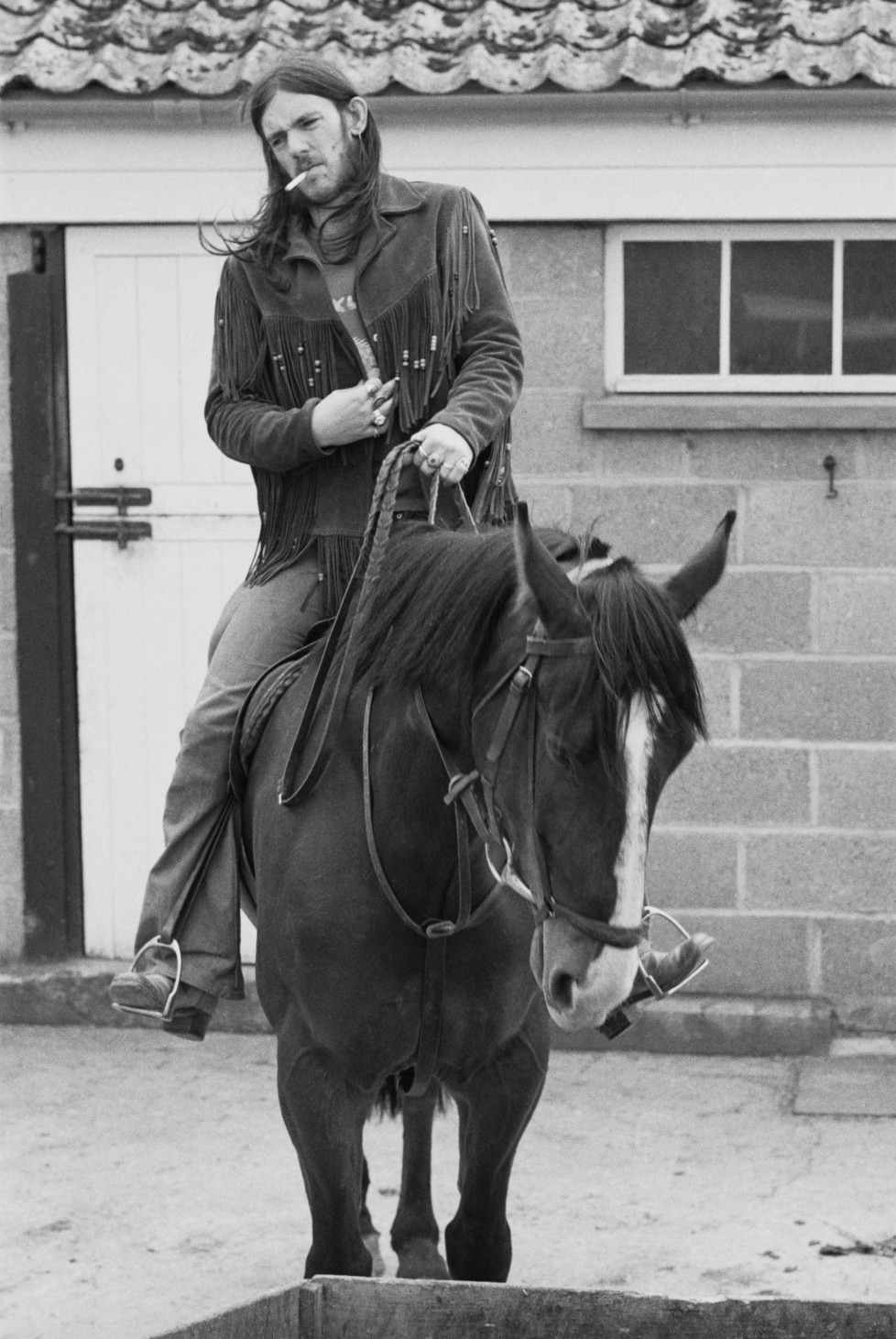 English bassist and singer Ian 'Lemmy' Kilmister, of space rock group Hawkwind, on horseback, 10th May1974. (Photo by Michael Putland/Getty Images)