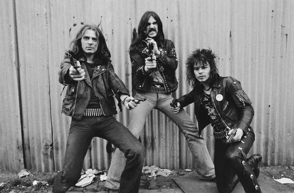 British heavy rock band Motorhead pose with pistols, London, 1978. Left to right: guitarist 'Fast' Eddie Clarke, bassist and singer Lemmy (Ian Kilmister) and drummer Phil 'Philthy Animal' Taylor. (Photo by Estate Of Keith Morris/Redferns)