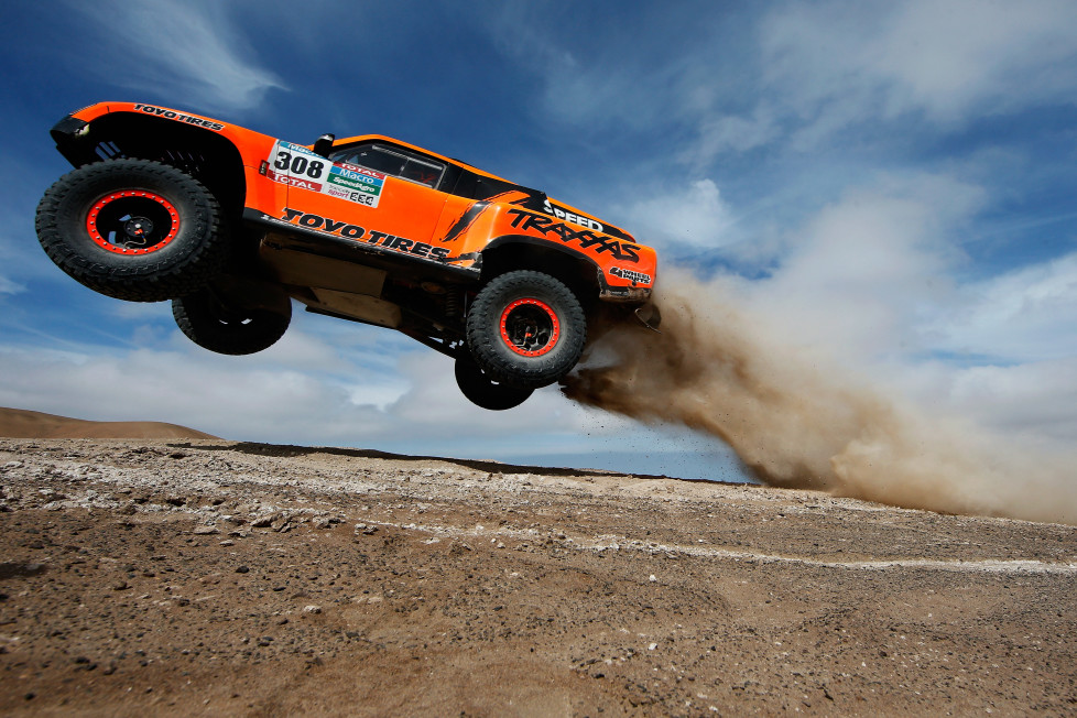 IQUIQUE, CHILE - JANUARY 13: #308 Robby Gordon and Johnny Campbell of the USA driving for Speed Energy Racing HST Hummer launches over a jump in the Atacama Desert during day 10 of the Dakar Rallly between Iquique on Calama January 13, 2015 in Iquique, Chile. (Photo by Dean Mouhtaropoulos/Getty Images)
