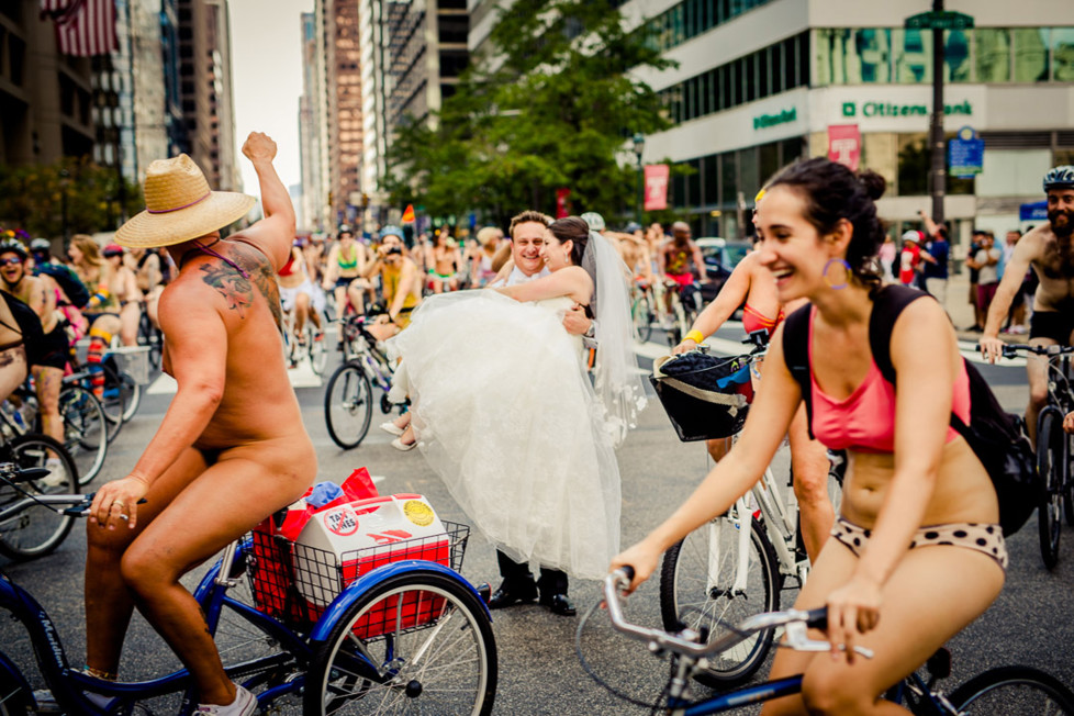 **MANDATORY PICTURE CREDIT** PIC BY: JPG PHOTOGRAPHY / ISPWP / CATERS NEWS (Pictured: Naked bike ride messes up couples wedding photo) - These hilarious photos will leave people WEDDING themselves with laughter. The images - which include photobombs, wardrobe malfunctions and unexpected animal behaviour - have been released by the International Society of Professional Wedding Photographs (ISPWP). Each year the society holds quarterly competitions, celebrating a variety of the best image from couples special days. Other categories in the ISPWPs completions include the likes Getting Ready, First Dance, Family Love, and a selection of portrait possibilities. - SEE CATERS COPY (FOTO: DUKAS/CATERSNEWS) *** Local Caption *** Funniest Wedding Photos of 2015