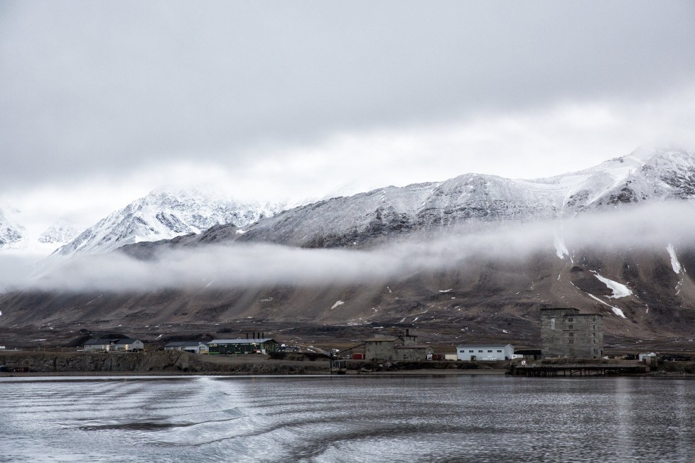 Low clouds are seen in the Kings Bay of Ny-Alesund, Svalbard, Norway, October 12, 2015. A Norwegian chain of islands just 1,200 km (750 miles) from the North Pole is trying to promote new technologies, tourism and scientific research in a shift from high-polluting coal mining that has been a backbone of the remote economy for decades. Norway suspended most coal mining on the Svalbard archipelago last year because of the high costs, and is looking for alternative jobs for about 2,200 inhabitants on islands where polar bears roam. Part of the answer may be to boost science: in Ny-Alesund, the world's most northerly permanent non-military settlement, scientists from 11 nations including Norway, Germany, France, Britain, India and South Korea study issues such as climate change. The presence of Norway, a NATO member, also gives the alliance a strategic foothold in the far north, of increasing importance after neighbouring Russia annexed Ukraine's Crimea region in 2014. REUTERS/Anna FilipovaPICTURE 19 OF 19 - SEARCH "SVALBARD FILIPOVA" FOR ALL IMAGESâ€¨