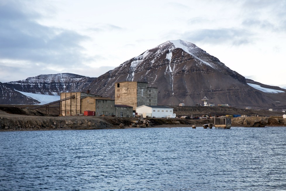 Warehouses and the old part of the Ny-Alesund, Norway settlement from the coal mining period which closed in 1963, are seen October 11, 2015. A Norwegian chain of islands just 1,200 km (750 miles) from the North Pole is trying to promote new technologies, tourism and scientific research in a shift from high-polluting coal mining that has been a backbone of the remote economy for decades. Norway suspended most coal mining on the Svalbard archipelago last year because of the high costs, and is looking for alternative jobs for about 2,200 inhabitants on islands where polar bears roam. Part of the answer may be to boost science: in Ny-Alesund, the world's most northerly permanent non-military settlement, scientists from 11 nations including Norway, Germany, France, Britain, India and South Korea study issues such as climate change. The presence of Norway, a NATO member, also gives the alliance a strategic foothold in the far north, of increasing importance after neighbouring Russia annexed Ukraine's Crimea region in 2014. REUTERS/Anna FilipovaPICTURE 15 OF 19 - SEARCH "SVALBARD FILIPOVA" FOR ALL IMAGESâ€¨