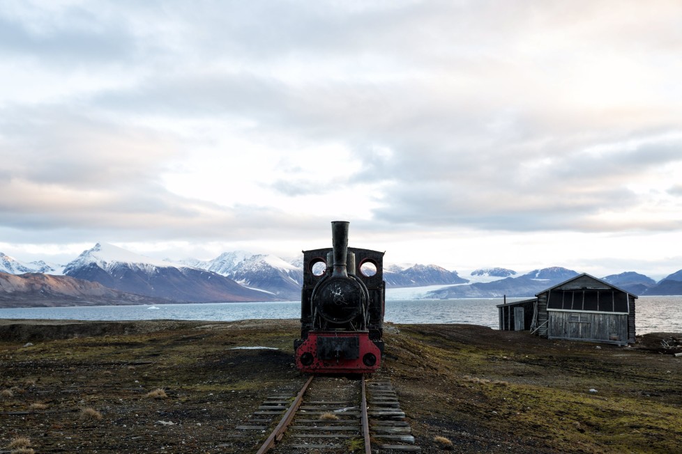 An old locomotive train that was used for transporting coal is preserved as a monument at Ny-Alesund, in Svalbard, Norway, October 11, 2015. A Norwegian chain of islands just 1,200 km (750 miles) from the North Pole is trying to promote new technologies, tourism and scientific research in a shift from high-polluting coal mining that has been a backbone of the remote economy for decades. Norway suspended most coal mining on the Svalbard archipelago last year because of the high costs, and is looking for alternative jobs for about 2,200 inhabitants on islands where polar bears roam. Part of the answer may be to boost science: in Ny-Alesund, the world's most northerly permanent non-military settlement, scientists from 11 nations including Norway, Germany, France, Britain, India and South Korea study issues such as climate change. The presence of Norway, a NATO member, also gives the alliance a strategic foothold in the far north, of increasing importance after neighbouring Russia annexed Ukraine's Crimea region in 2014. REUTERS/Anna Filipovaâ€¨PICTURE 14 OF 19 - SEARCH "SVALBARD FILIPOVA" FOR ALL IMAGES