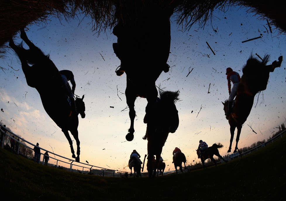 CHELTENHAM, ENGLAND - MARCH 17: Runners and riders clear a jump in the Fulke Walwyn Kim Muir Challenge Cup Handicap Chaseon day three, St Patrick's Thursday, of the Cheltenham Festival at Cheltenham Racecourse on March 17, 2016 in Cheltenham, England. (Photo by Mike Hewitt/Getty Images)