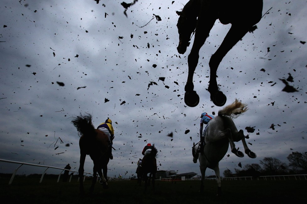 WETHERBY, ENGLAND - MARCH 22: Horses clear a fence during the Racing UK Profits Returned To Racing Handicap Steeple Chase at Wetherby Racecourse on March 22, 2016 in Wetherby, England. (Photo by Alex Livesey/Getty Images) *** BESTPIX ***