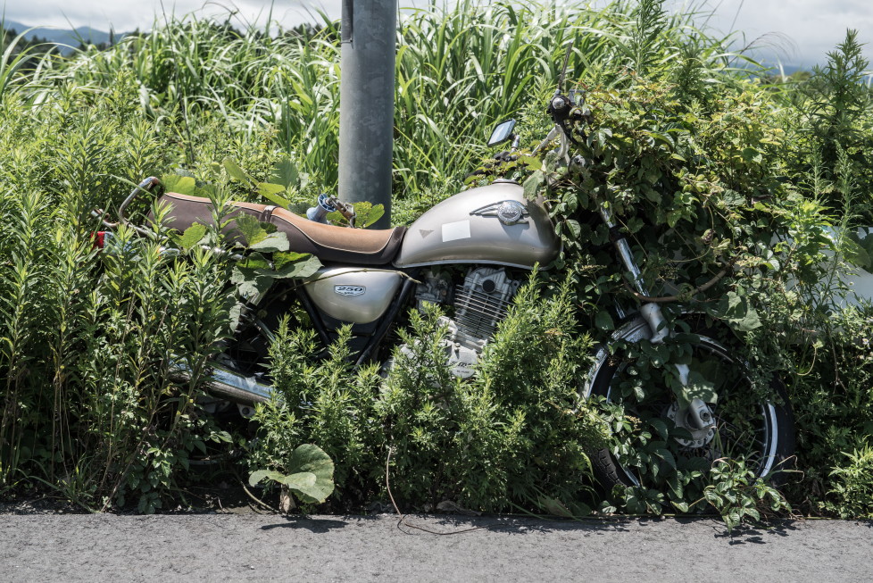 EXCLUSIVE IMAGES. PLEASE TRY FOR THE HIGHEST POSSIBLE FEES. MANDATORY CREDIT: Arkadiusz Podniesinski/REX Shutterstock Mandatory Credit: Photo by Arkadiusz Podniesinski/REX Shutterstock (5224634n) A motorbike left next to a lamppost in 2011. Since the disaster weeds have grown over much of the bike's wheel. Fukushima, Japan - Sep 2015 FULL COPY: http://www.rexfeatures.com/nanolink/r7ku MINIMUM USE FEE A photographer has taken stunning and revealing pictures of the exclusion zone from the 2011 Fukushima Nuclear Disaster. Within a 20km radius the radioactive exclusion zone demonstrates the dangerous nature of nuclear energy. A network of abandoned towns and villages that once housed hundreds of thousands of people, the exclusion zone of the largest nuclear accident since Chernobyl is eerie and frightening. (FOTO:DUKAS/REX)