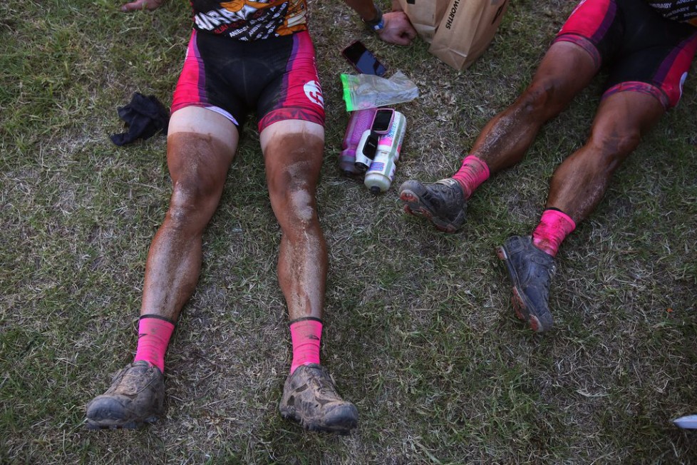 epa05211481 Riders with dust lines on their legs rest after completing the 108km Stage 1 of the 2016 ABSA Cape Epic mountain bike race in Saronsberg South Africa, 14 March 2016. Scores of riders where eliminated from the race after missing the cut off time for the stage. The ABSA Cape Epic is often described as the 'Tour de France' of mountain biking and will see 1,200 riders racing over 652km in eight stages and 15,100m of climbing. UCI professional racers ride alongside amateur riders during the eight day long race. EPA/KIM LUDBROOK